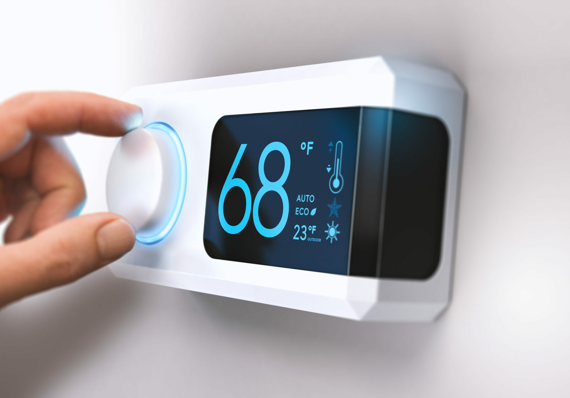 Hand turning a home thermostat knob to set temperature on energy saving mode. fahrenheit units. Composite image between a photography and a 3D background.